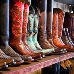 a shelf of leather cowboy boots