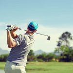 a man finishing a golf swing