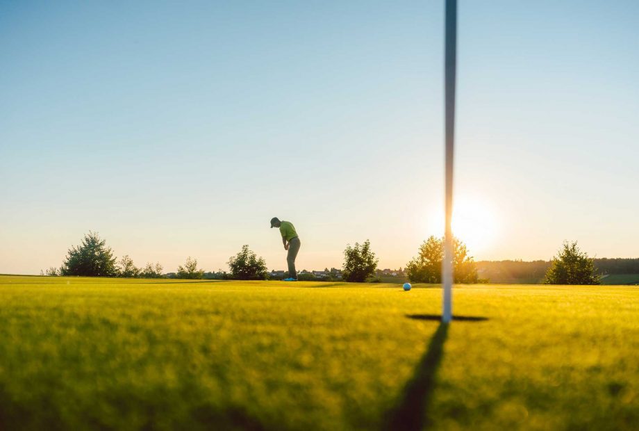 golfing at sunset
