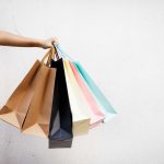 a hand holding shopping bags