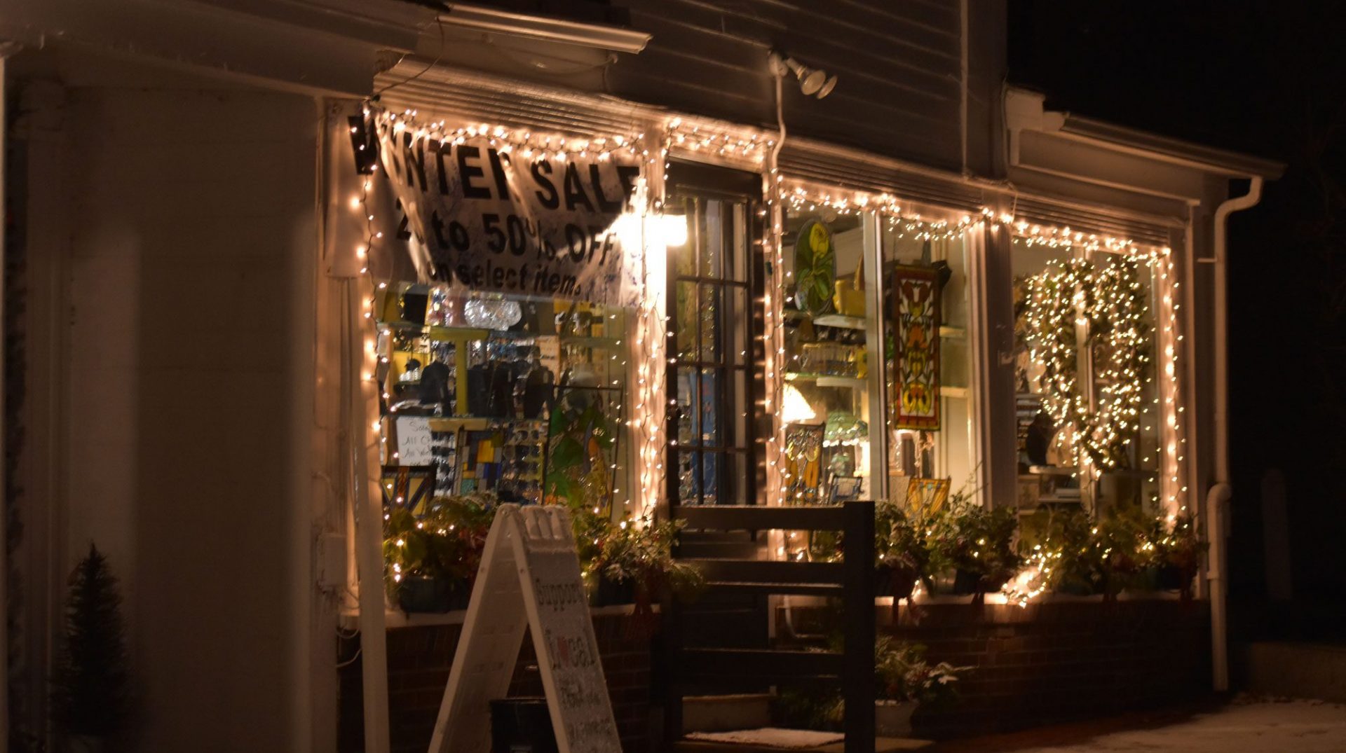 white holiday lights on a storefront at night in Sturbridge, Massachusetts